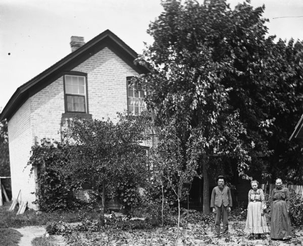 The Ullrich family standing in a garden in front of their home.