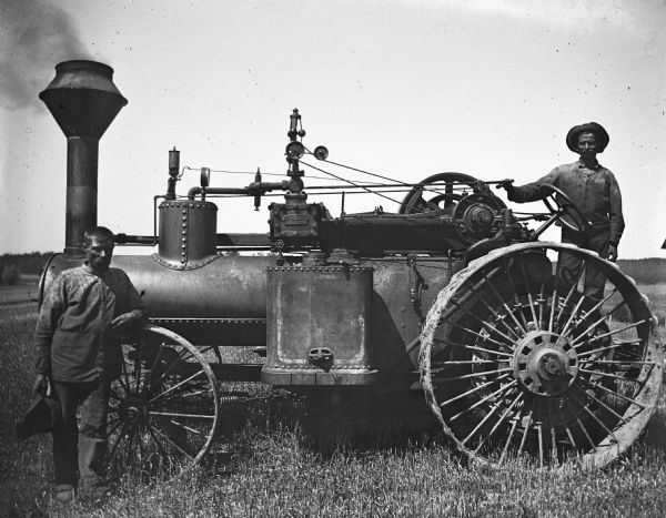 August and William Kuckhahn posing with an Aultman-Taylor steam traction engine.