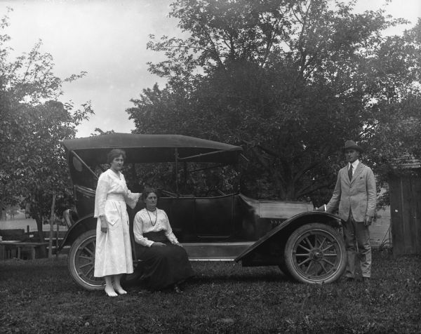 Jennie, Florentina, and Edgar Krueger posing next to a 1917 Chevrolet touring car on the Krueger farm.