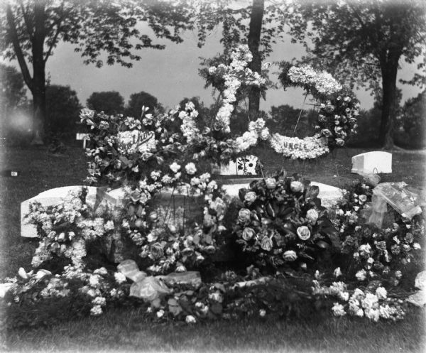 Floral funeral arrangements for August Krueger at Oak Hill Cemetery.