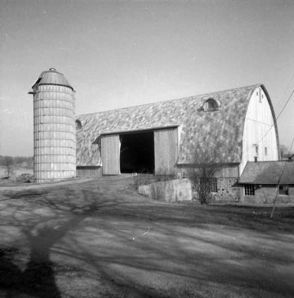 View across driveway of the new dairy barn and silo.