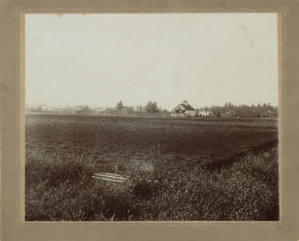 Cranberry marshes and irrigation ditch. The family home, barn and outbuildings are in the background.