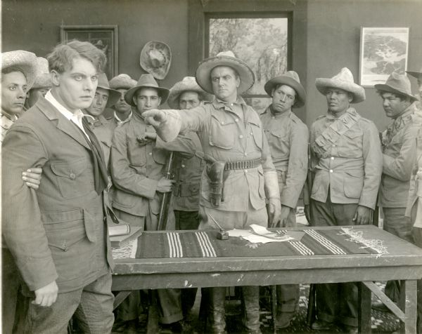 Bruce McLean (played by Forrest Stanley) has been captured by the Mexican revolutionary Emiliano Pacheco (Howard Davies) and his followers.