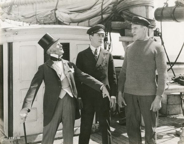 Shipowner Cappy Ricks (played by Charles Abbe) and seamen Matt Peasley (Thomas Meighan) and Ole Peterson (Ivan Linow) onboard a ship in a publicity still from "Cappy Ricks" (Lasky 1921).