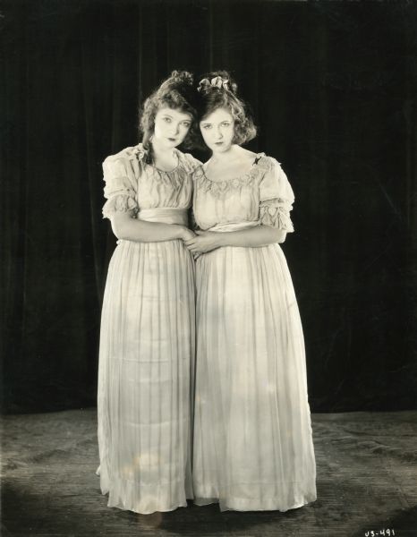 Lillian Gish, in costume as Henriette Girard, and Dorothy Gish, as Louise Girard, in a publicity photograph for D.W. Griffith's 1921 production "Orphans of the Storm."