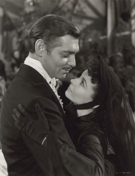 Clark Gable (playing Rhett Butler) embraces Vivien Leigh (Scarlett O'Hara) who is dressed in mourning clothes in a publicity still from the Selznick production "Gone with the Wind (Selznick 1939).