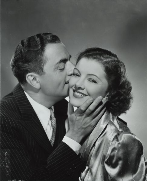 William Powell kisses Myrna Loy on the cheek in this publicity still from "Double Wedding" (MGM 1937).
