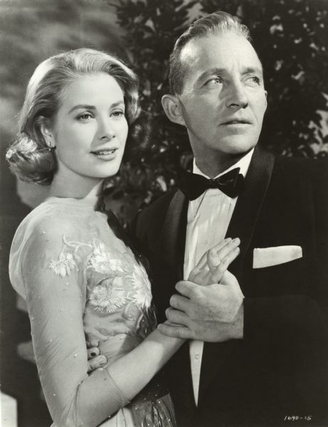 Grace Kelley holds hands with Bing Crosby in a publicity still from "High Society" (MGM 1956).