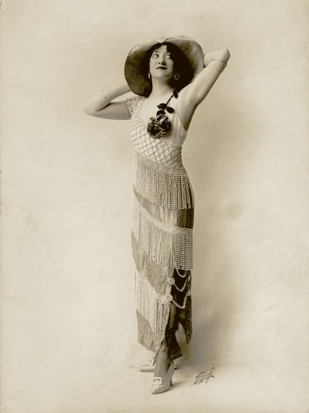 Dorothy Jardon in a large hat and beaded dress in a publicity photograph for "A Winsome Widow," a musical comedy that played at the Ziegfeld Moulin Rouge.
