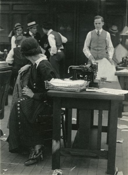 Jane Pepper (played by Irene Hunt), a reporter for "The Daily Mail," turns around at her typewriter desk to overhear a conversation in the newsroom. Frank Darien, perhaps playing her editor, watches her.