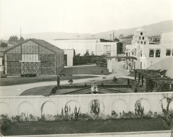 General view of the American Film Company studio located at State Street and Mission Street in Santa Barbara, California. The American Film Company, also known as the Flying A Studios, made silent films here from 1912 to 1922. Visible are the Moorish style headquarters building, a glass studio, and a formal garden.