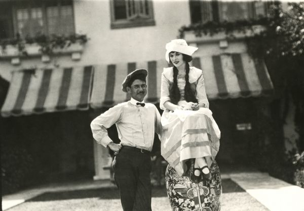Original caption: "Anita Stewart and her director, Bertram Bracken, taken between filming of scenes at Anita's home."