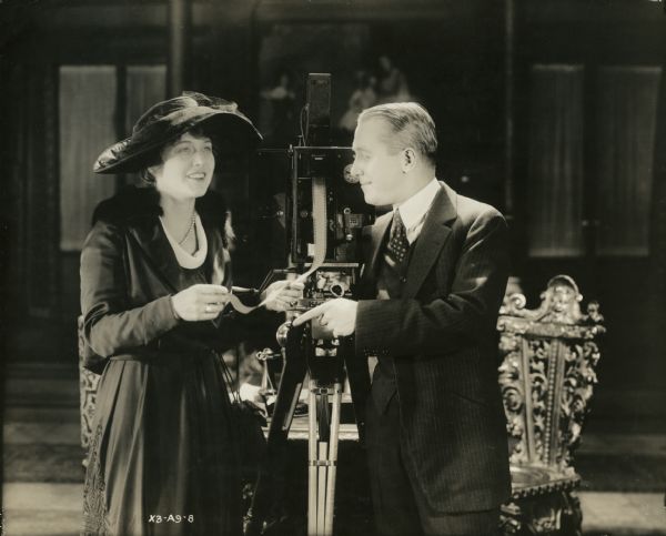 Original caption: "FROM ARTCRAFT PICTURES CORP. Pete Schmid.
Elsie Ferguson, Artcraft's newest recruit gets her initial lessons in film technique from George M. Cohan, who is at present appearing in his second motion picture, 'Seven Keys to Baldpate'. Miss Ferguson will shortly commence activities on her initial photoplay, 'Barbary Sheep.'"