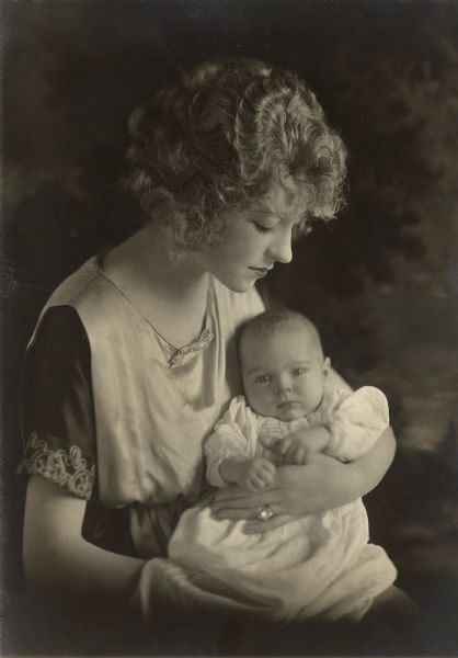Studio portrait of the silent film actress Mollie King (Alexander) holding her infant son Kenneth Deedes Alexander Jr.