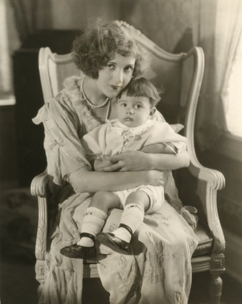 The silent film actress Constance Talmadge holds James Talmadge Keaton in her lap. James (also known as Joseph) was the first child born to Constance Talmadge's sister Natalie and Buster Keaton.