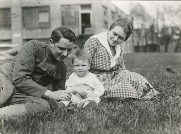 Essanay silent film star Bryant Washburn in U.S. Army sergeant's uniform sits on the grass with his little son Bryant Washburn, Jr., and his wife, the actress Mabel Forrest.