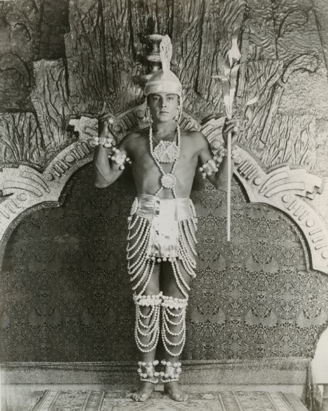 Rudolph Valentino poses wearing very little but an elaborate breechcloth decorated with pearls for his role as the Maharajah of Dharmagar in "The Young Rajah."