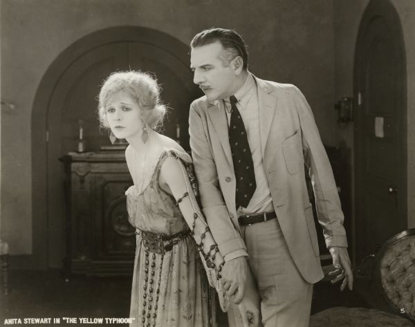 Berta Nordstrom (played by Anita Stewart) struggles with John Mathison (Ward Crane) in a scene still from "The Yellow Typhoon" (1920).