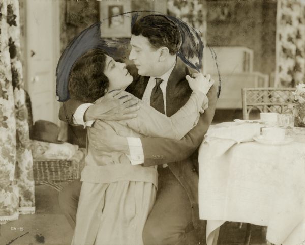 Myra and Bryan (played by Pauline Frederick and Irving Cummings) are locked in an embrace in a highly retouched scene still from "The World's Great Snare."