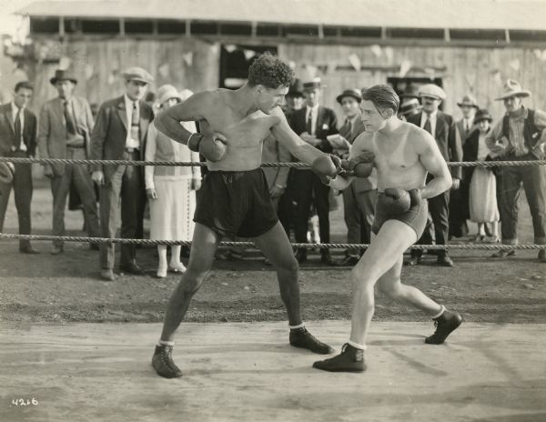Billy Sullivan (right) boxes a larger man in "Fighting Mad," perhaps one of "Leather Pushers" series of Universal films made in 1923 and 1924. Billy Sullivan (aka William Arthur Sullivan) also appeared as a boxer in "The Battling Cowboy" series.