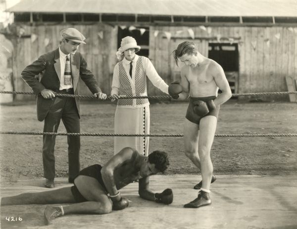 Billy Sullivan (right) has knocked his opponent to the mat in "Fighting Mad," perhaps one of the  "Leather Pushers" series of Universal films made in 1923 and 1924. Billy Sullivan (aka William Arthur Sullivan) also appeared as a boxer in "The Battling Cowboy" series.