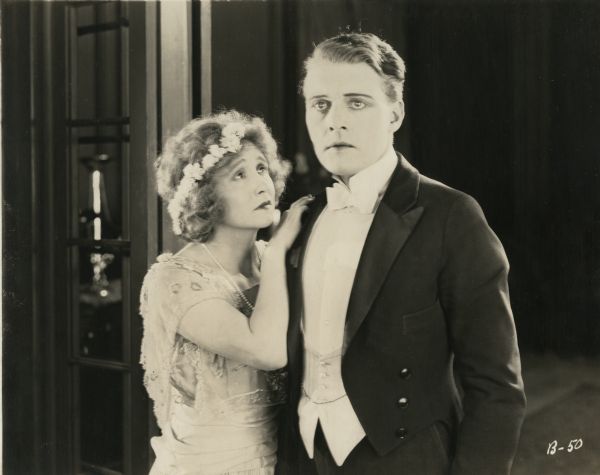 Bessie Barriscale and Forrest Stanley, both wearing formal evening wear, pose in a soulful publicity still for "A Woman Who Understood."