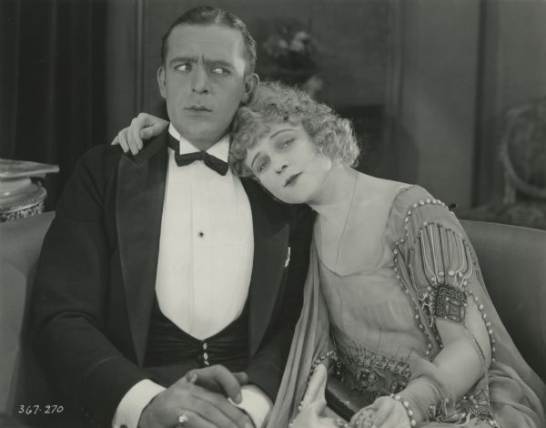Wallace Reid and Wanda Hawley sit side by side in a scene still from Cecil B. DeMille's 1921 production "The Affairs of Anatol."