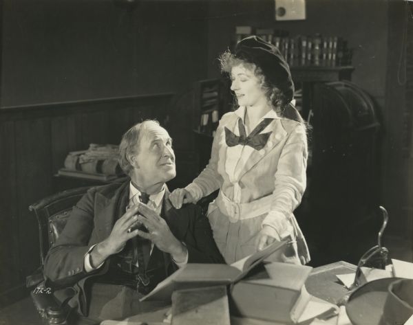 Abel Manning (played by Theodore Roberts) and his daughter Joan (Maude Fealy) are in his law office in a scene still from "The American Consul."