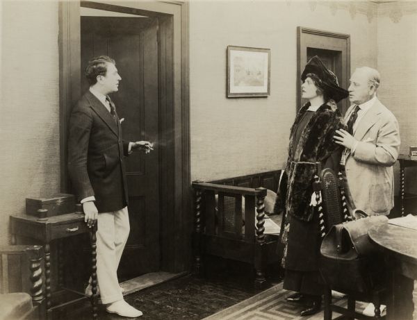 Looks of love and surprise pass between Jasper Mallory (played by Irving Cummings) and Elizabeth Carter (Ethel Barrymore) in a scene still for "An American Widow." Standing behind Barrymore is actor Charles Dixon.