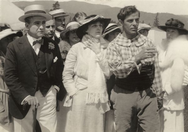 Donald Hall, wearing a straw boater and bow tie, Naomi Childers, in white with a scarf, and Antonio Moreno, dressed as a gypsy, in a scene still from the 1915 Vitagraph production "Anselo Lee."