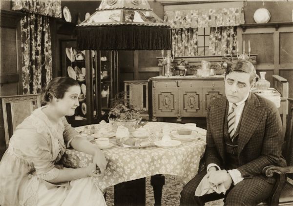 Rosemary Theby and Harry Myers sit at a breakfast table in a scene still for the 1915 Victor silent film "Baby."