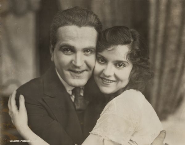 The actors Frank Morgan and Madge Kennedy embrace in this publicity still for "Baby Mine" (Goldwyn 1917). In the silent film they play Alfred and Zoie, a married couple.
