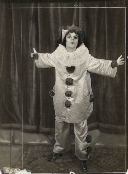 In this scene still for "Back to Broadway" (Vitagraph 1914), Anita Stewart poses as the clown Pierrot and mimes a big kiss.