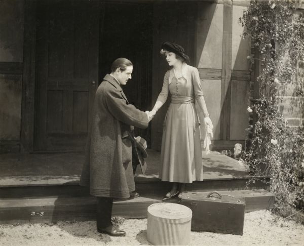 Forced to leave the girl he loves, Andre d'Eguzon (played by David Powell) sadly says goodbye to Helen de Travillac (Anna Murdock) in a scene still for the silent drama "The Beautiful Adventure."