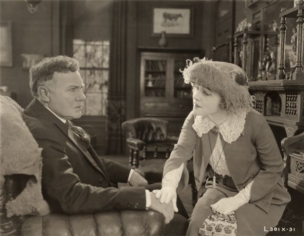 Charles K. French and Ethel Clayton have a heart to heart talk seated in comfortable parlor in this scene still for the silent drama "Beyond."