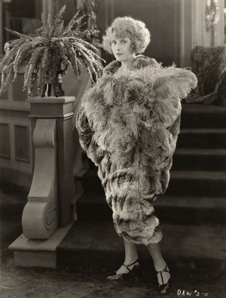 Pearl White, in character as Sally Marrio, wears a chinchilla coat in a publicity still for the silent melodrama "Beyond Price."