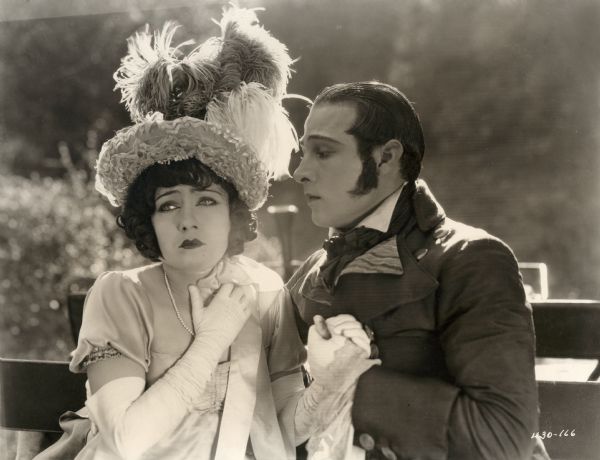 Fighting tears, Theodora Fitzgerald (played by Gloria Swanson) looks away from Lord Hector Bracondale (Rudolph Valentino) who stares at her with deep feeling in a scene still from the silent drama "Beyond the Rocks."