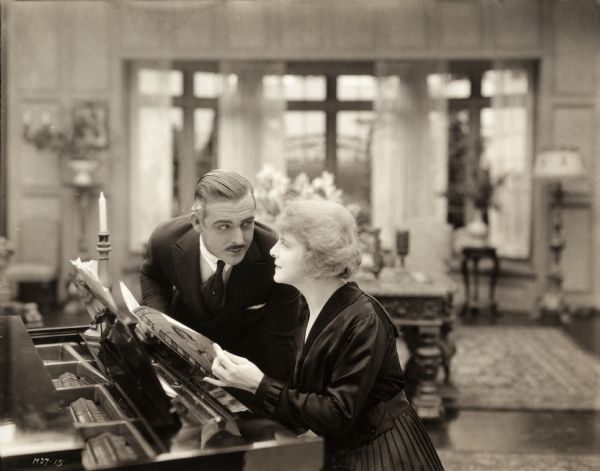 Jack Fyfe (played by Wallace Reid) and Stella Benton (Kathlyn Williams) share a romantic moment at the piano in a scene still for the silent drama "Big Timber."