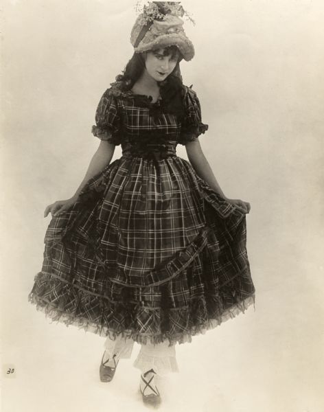 In this publicity still for D.W. Griffith's silent drama "The Birth of a Nation," Mae Marsh is in Southern antebellum costume for her role as Flora Cameron.