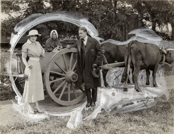 In a heavily retouched scene still for the silent drama "The Black Butterfly," Sonia Smirnov (played by Olga Petrova) and Alan Hall (Mahlon Hamilton) stand beside an ox cart containing a peasant woman holding apples.