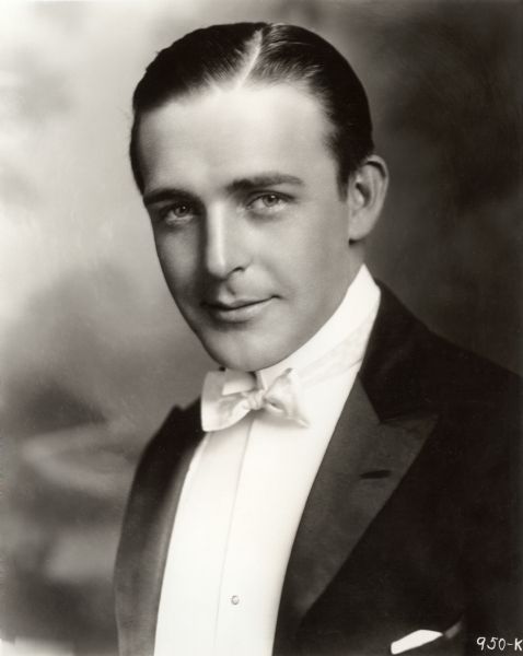 Head and shoulders studio publicity portrait of silent film star Wallace Reid in white tie and tails.