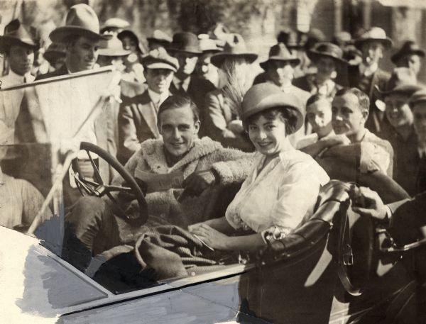 Publicity still from 1913 heavily retouched for the July 7, 1928, issue of Liberty (magazine). The original caption reads: "Wallace Reid and Dorothy Davenport (now Mrs. Reid) being greeted by the Universal employees on their return from their wedding ceremony to Universal City."