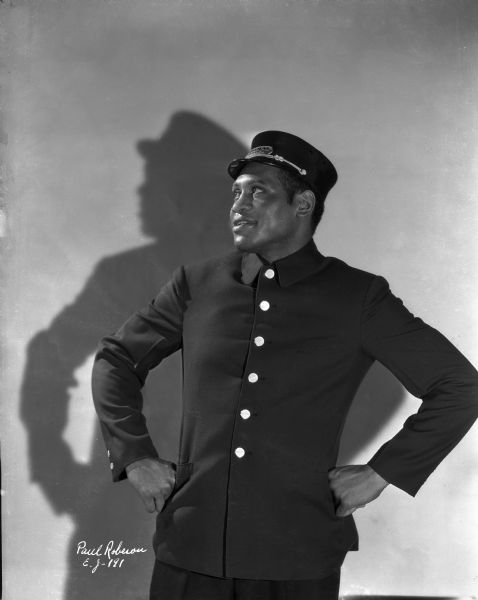 Studio publicity portrait of Paul Robeson dressed in a Pullman porter's uniform for the 1933 film "The Emperor Jones."
