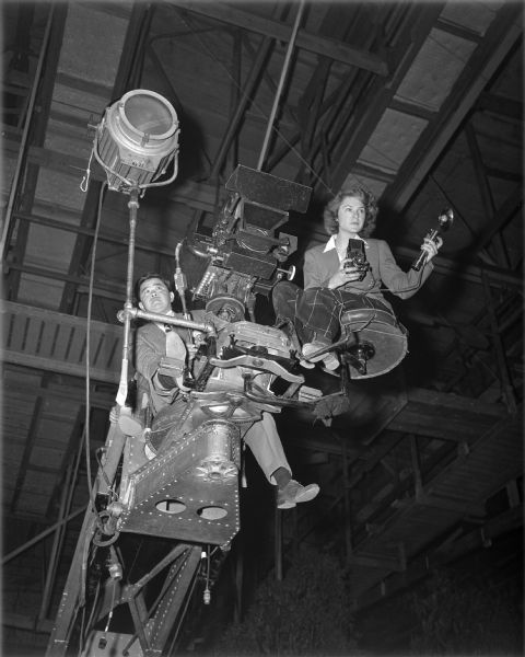 Cinematographer James Wong Howe and photojournalist Margaret Bourke-White posed high up on a motion picture camera crane during the production of "The North Star" in 1943.
