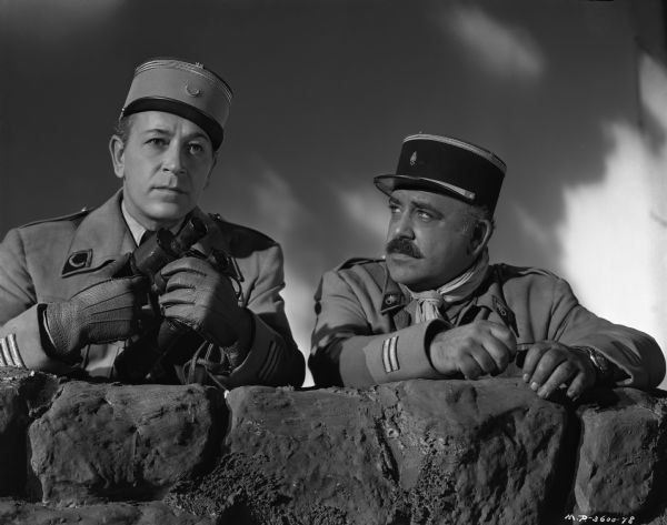 Actors George Raft and Akim Tamiroff as the French legionnaires Captain Paul Gerard and Lieutenant Glysko in a publicity still for the 1949 drama "Outpost in Morocco."