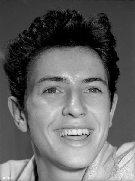Facing the camera, Farley Granger smiles broadly in a publicity still for "The North Star."