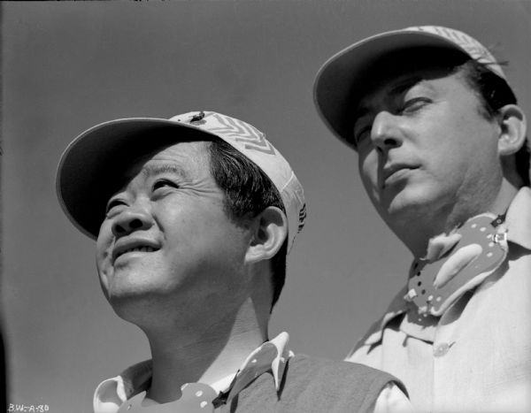 Cinematographer James Wong Howe (left) and director Lewis Milestone squint in bright sunlight in a production still for "The North Star."