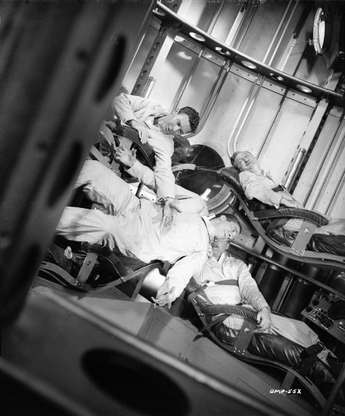 Three astronauts are strapped into their bunks (left to right, John Archer, Tom Powers, and Warner Anderson), but Dick Wesson has begun to float free. (The wires that suspend Wesson can be clearly seen.)