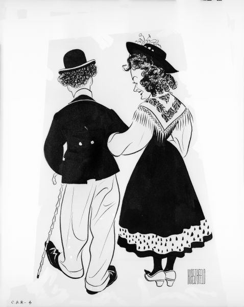 Al Hirschfeld's drawing shows Charlie Chaplin's Jewish barber character and Hannah (Paulette Goddard) walking away arm in arm. This cartoon was produced to promote "The Great Dictator."