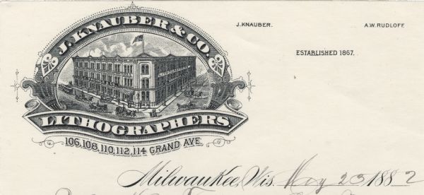 Letterhead of J. Knauber & Company of Milwaukee, Wisconsin, with a three-quarter view of the company building and traffic in the surrounding streets contained within a cartouche embellished with printer's ornaments and a banner underneath. Printed on lined note paper.